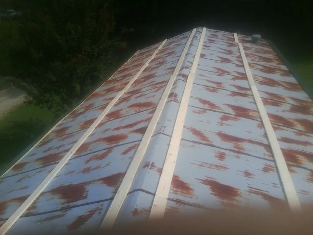 Rusted metal roof panels with new wood purlins before replacement — Storm Damage Roof Repair in Cowpens by Roofing Brothers